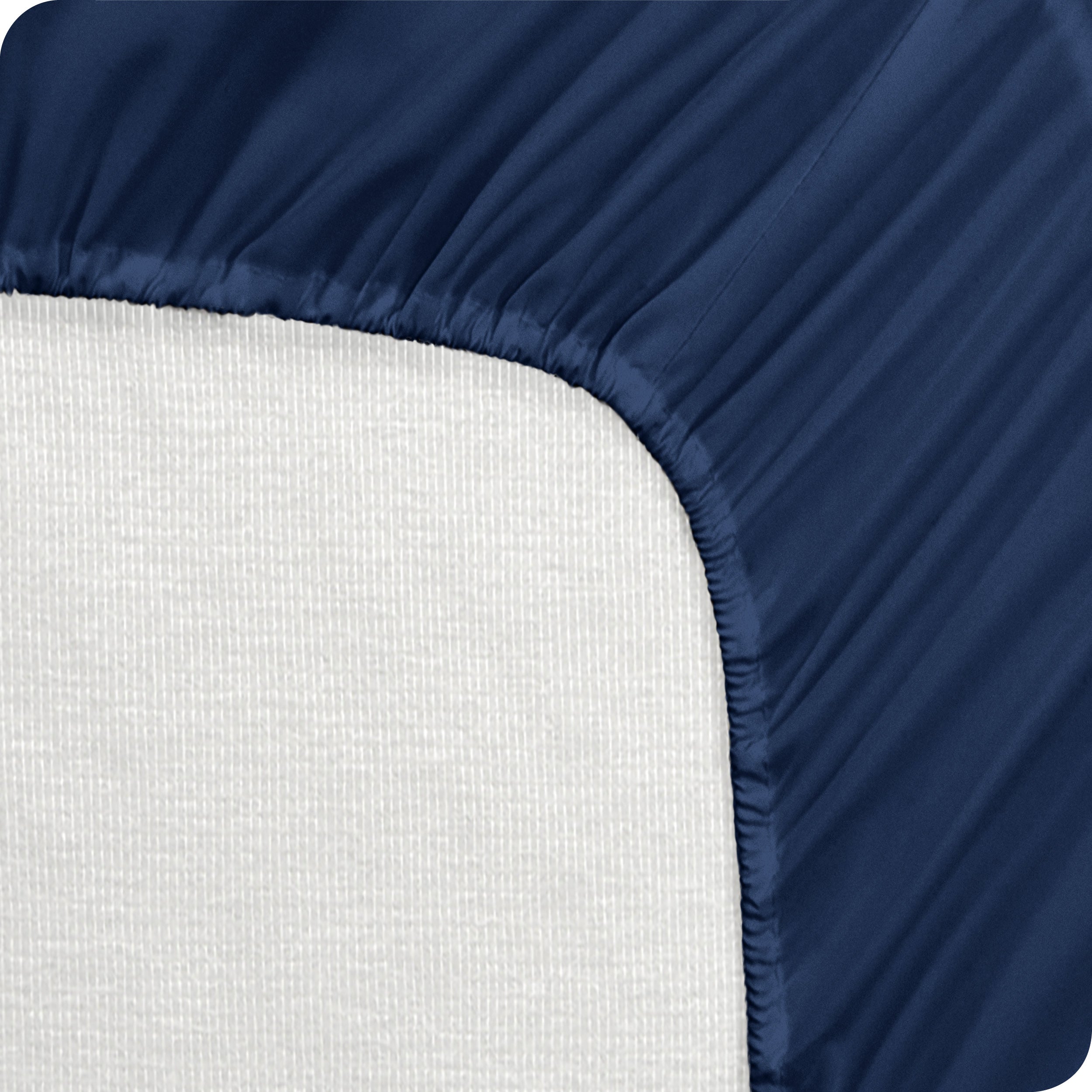 A mattress pad wrapped around the side and back of a mattress