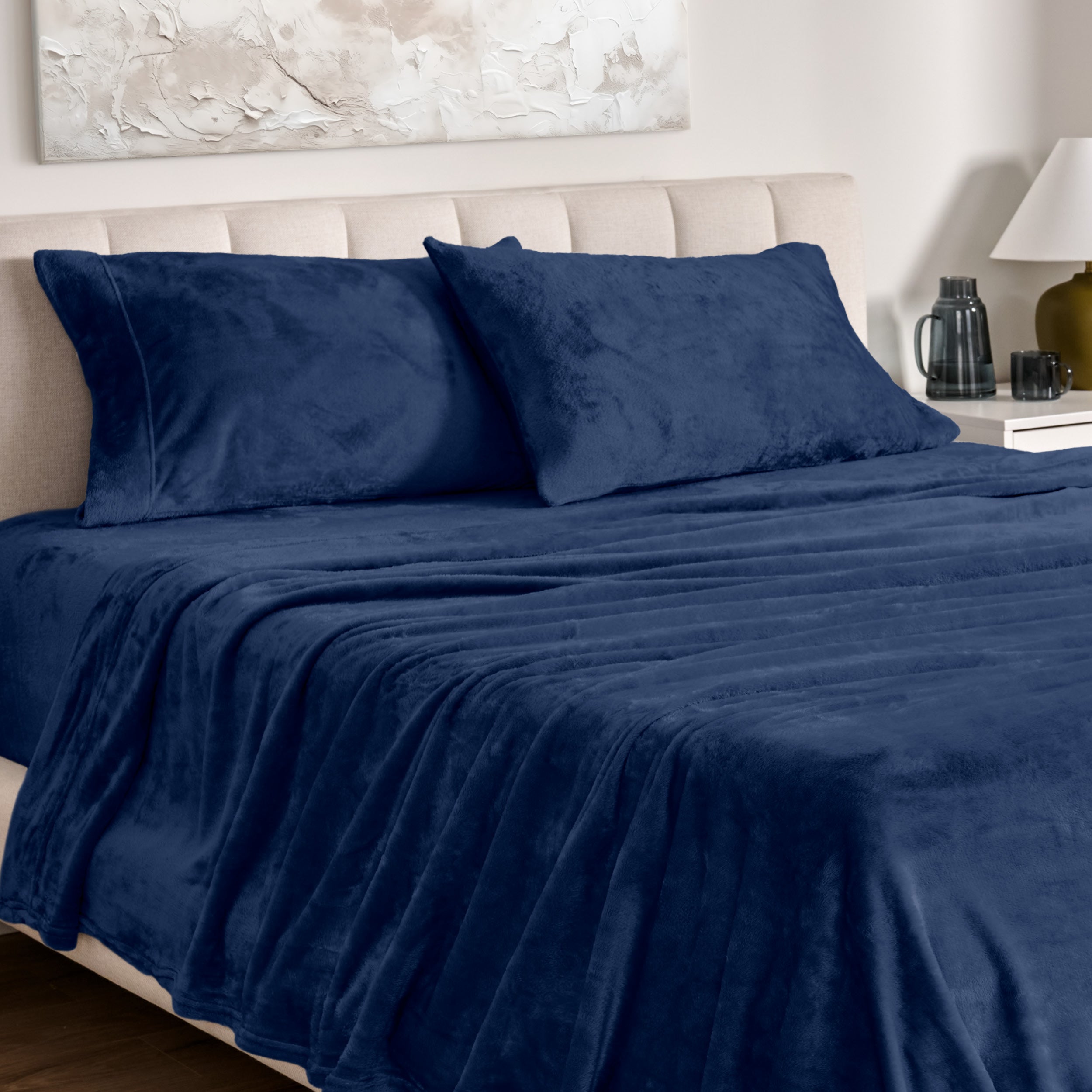Microplush bed sheets and pillowcases on a bed with a neutral headboard and decor.