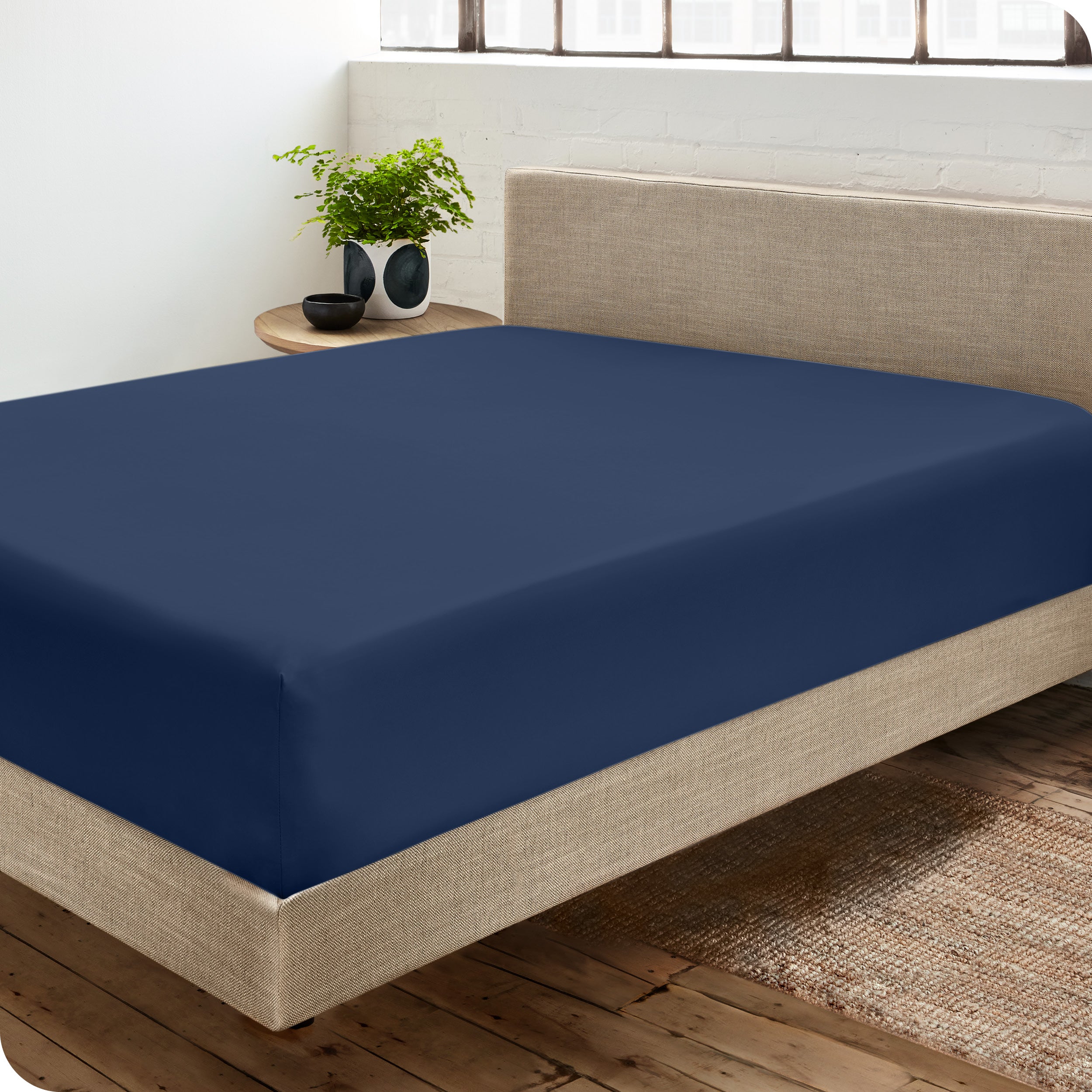 A sateen fitted sheet on a bed
