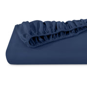 A single fitted sheet folded neatly showing part of the elastic