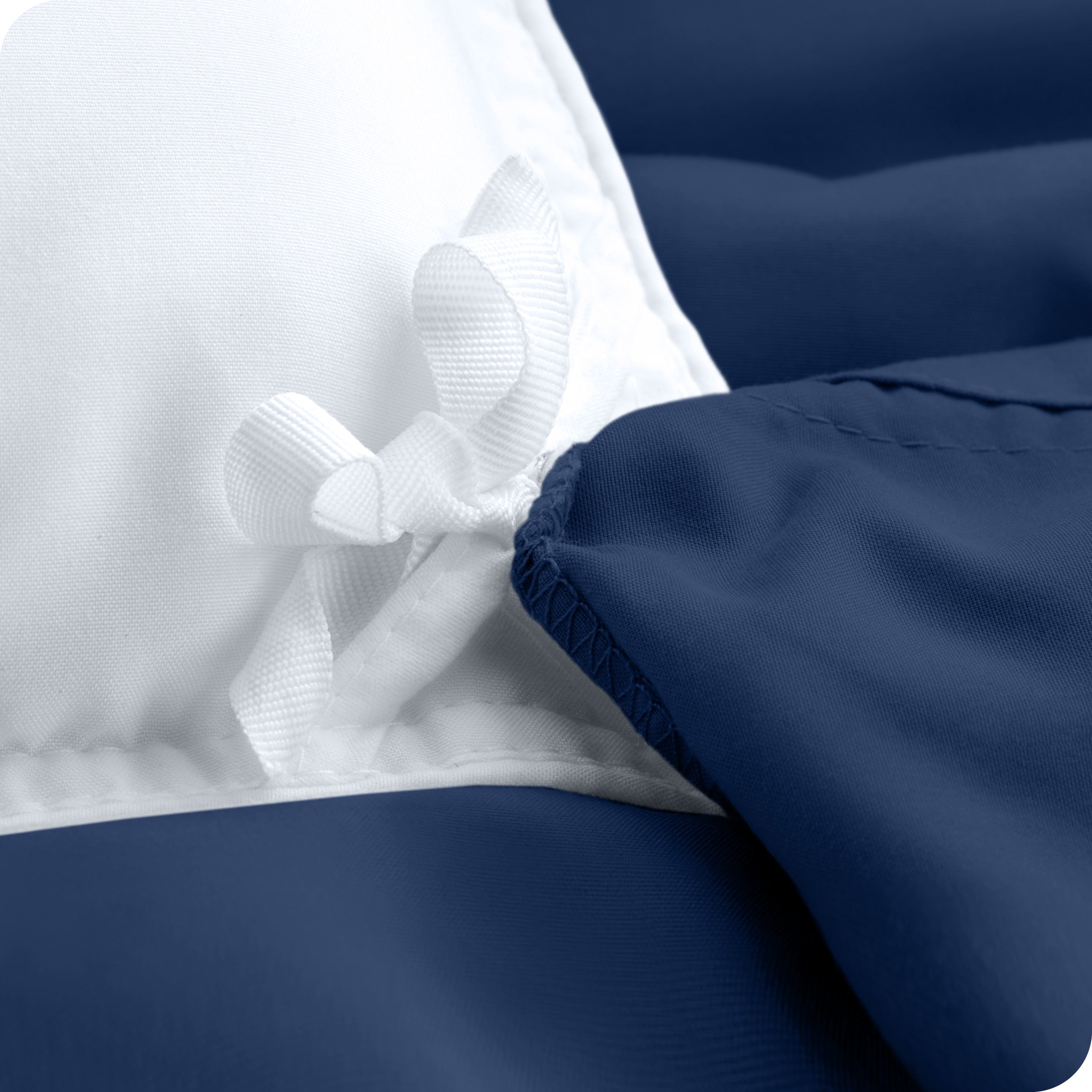 The corner ties of a duvet cover attached to a duvet insert