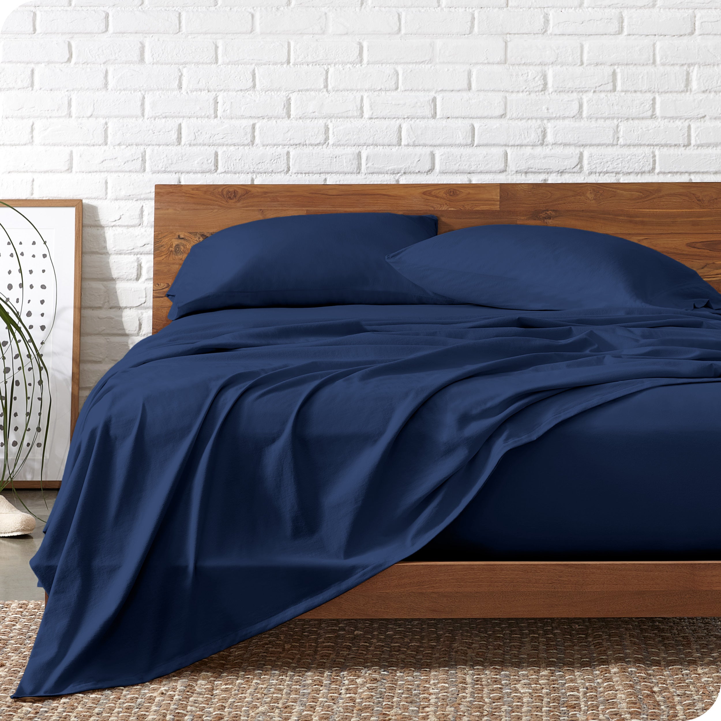 Organic jersey sheets on a bed with a wooden bed frame