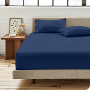 Percale fitted sheet on a mattress with matching pillowcases on pillows