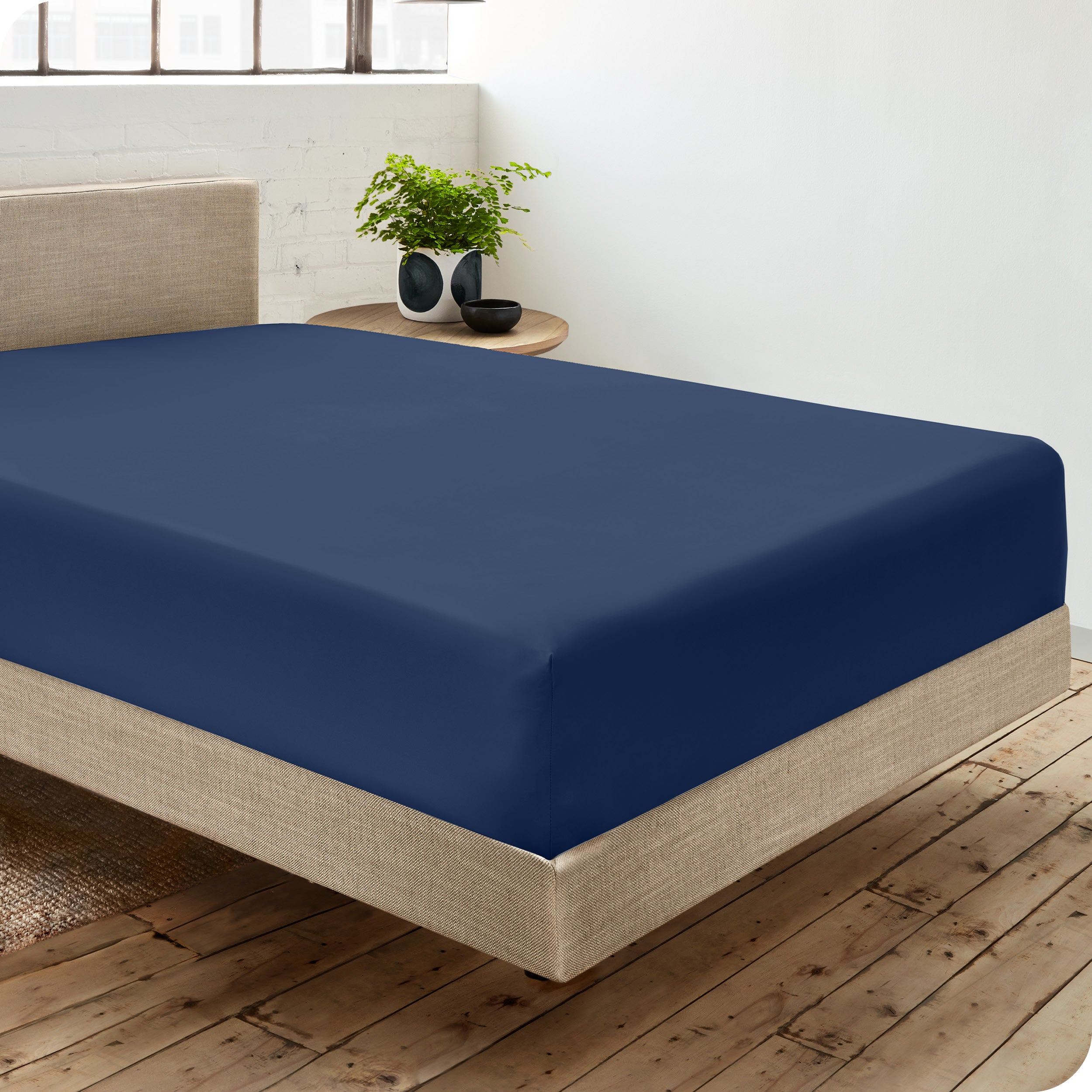A single organic cotton fitted sheet on a bed