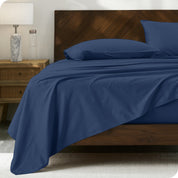 Percale sheet set on a bed with a wooden headboard