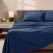 View of fleece sheets from the end of a bed with the top sheet draped over the side and end