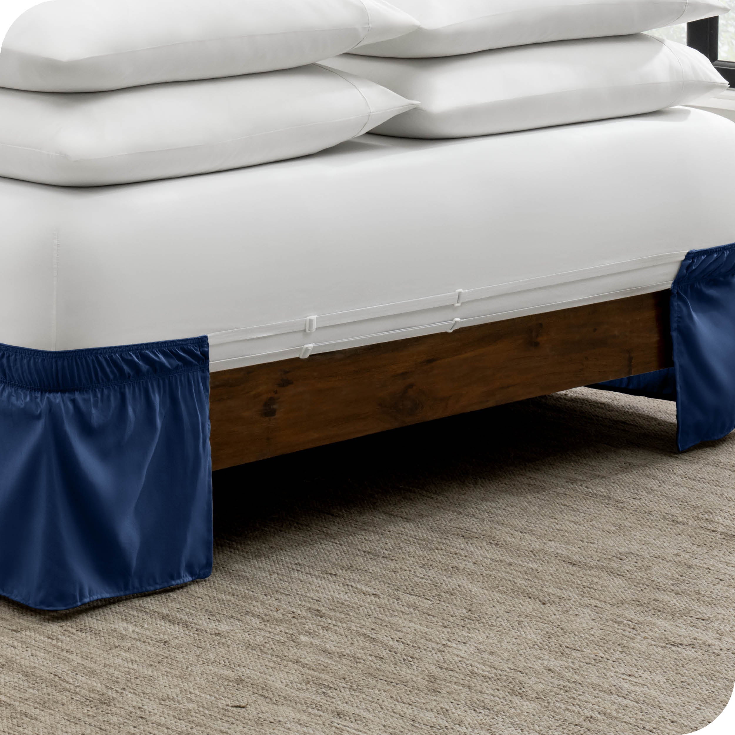 The adjustable elastic belt of a bed skirt wrapped around the mattress