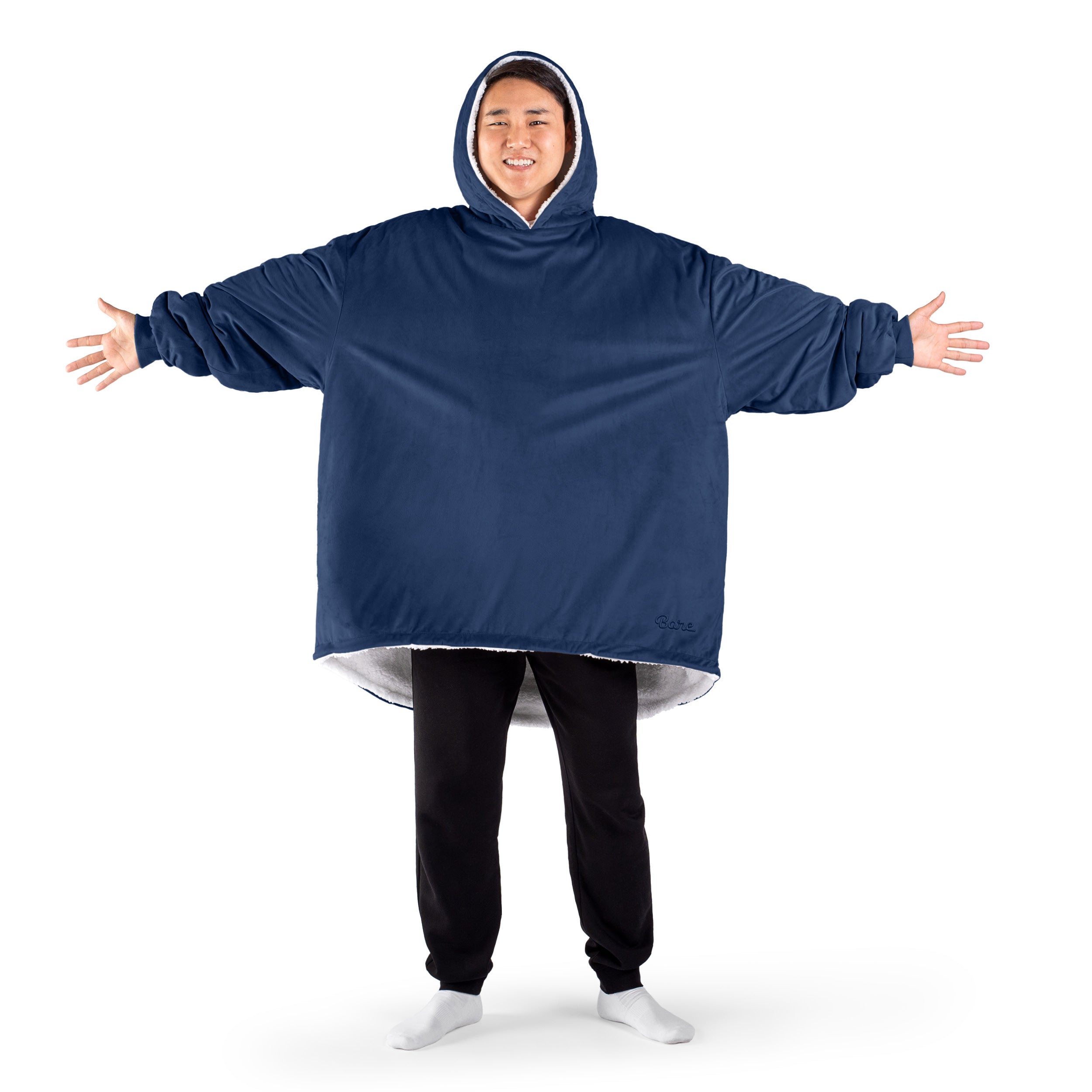 An adult with a sherpa wearable blanket on