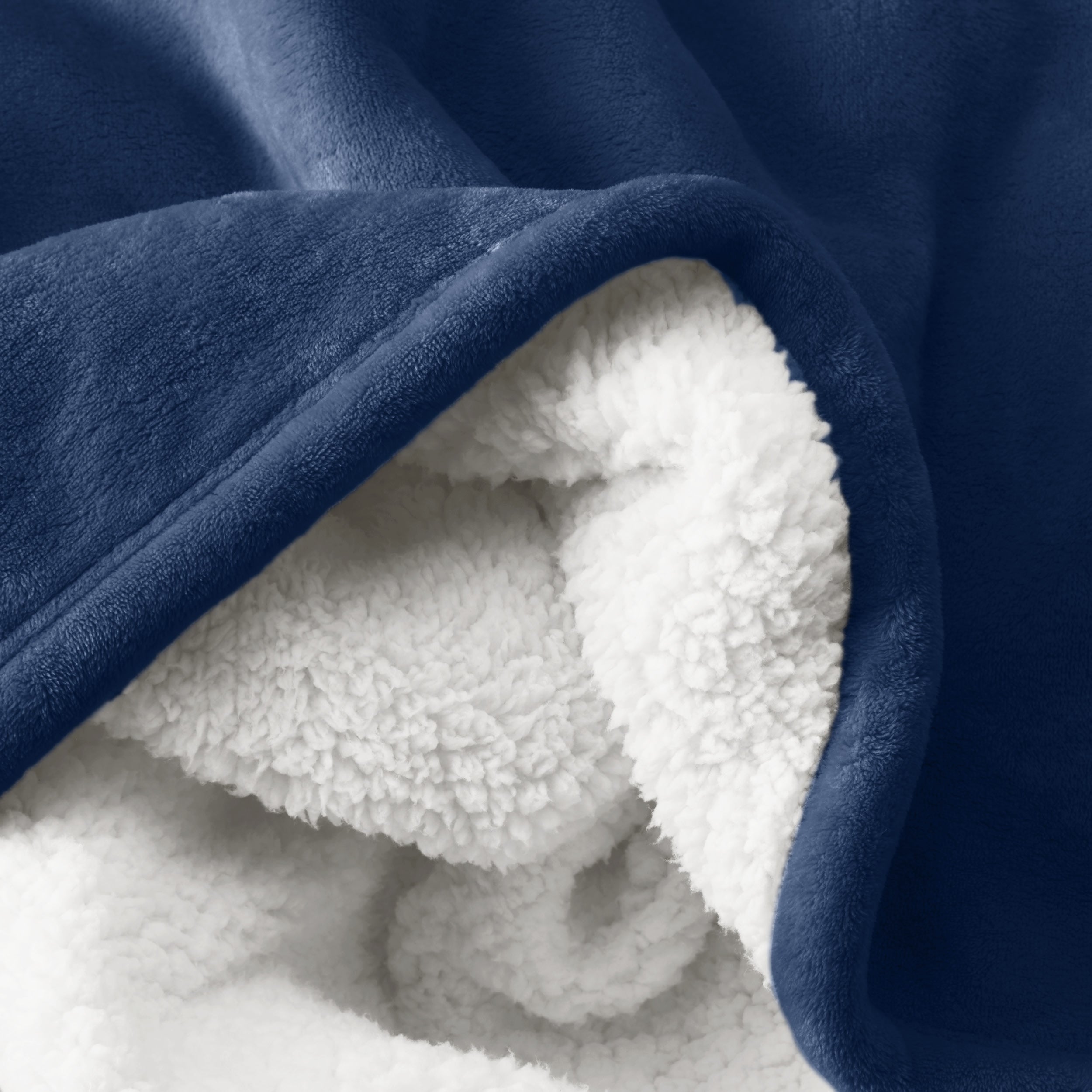 Close up of sherpa blanket showing texture of velvety soft side and sherpa backing