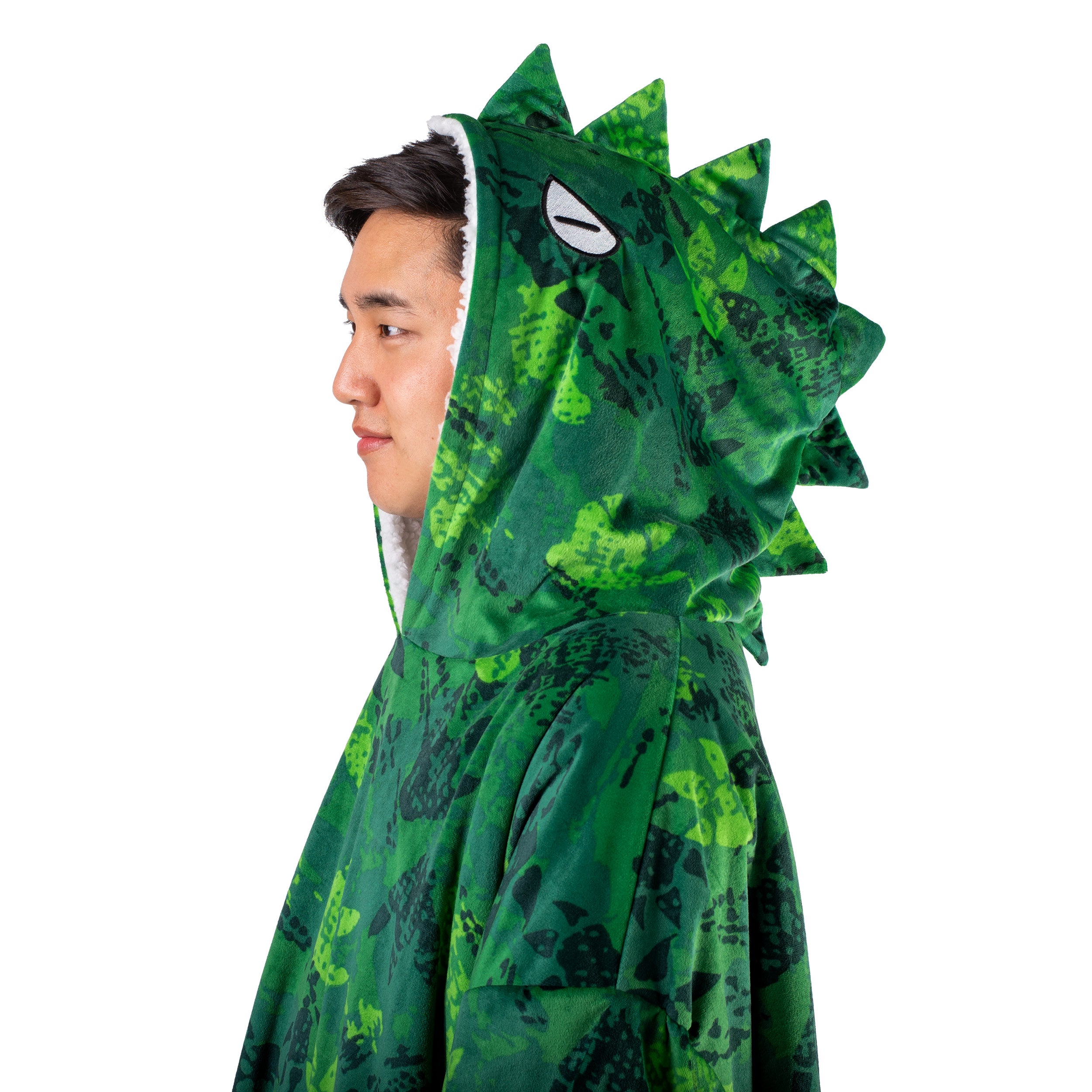 An adult with a sherpa wearable blanket on