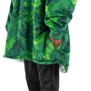 An adult with a hooded wearable blanket on