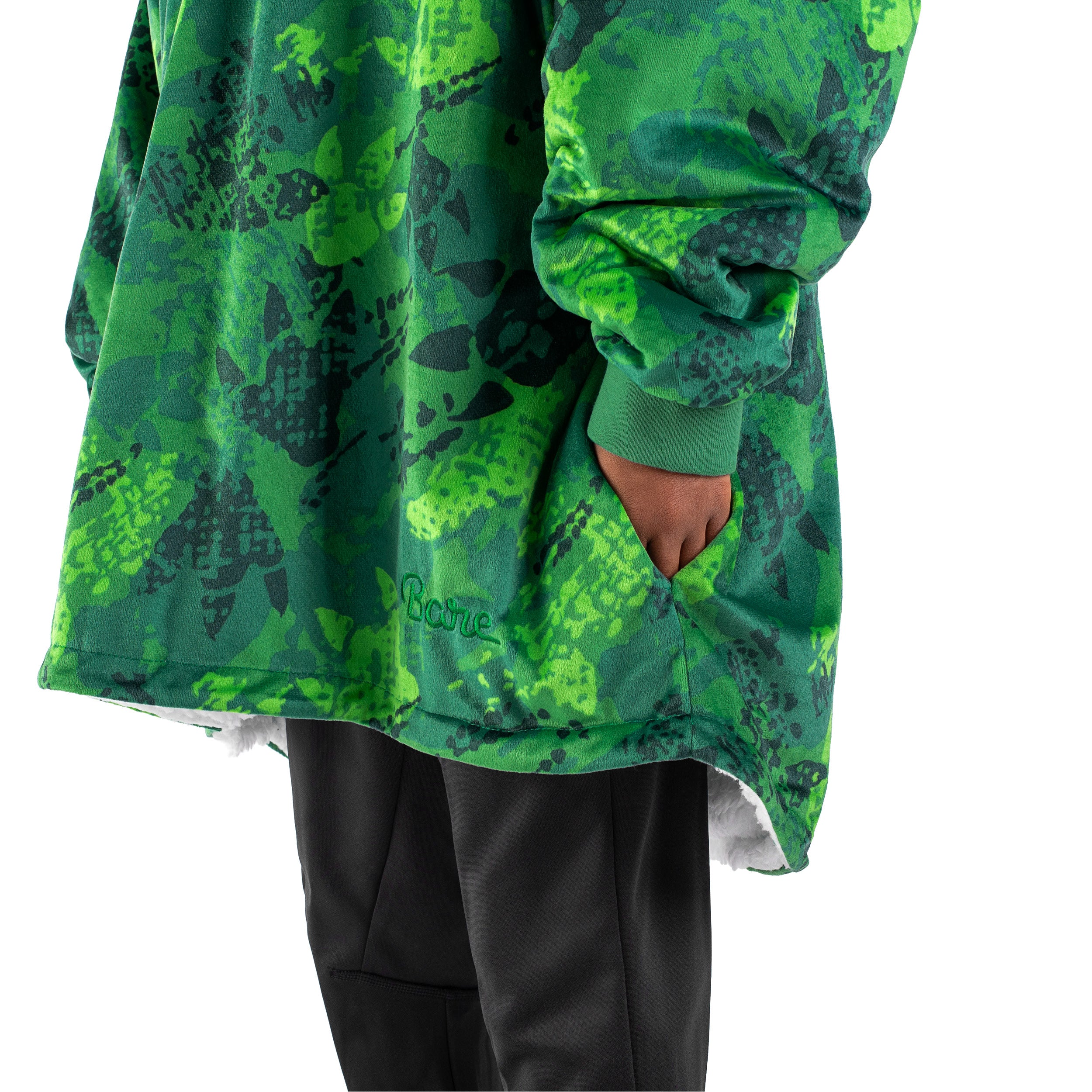 An adult with a hooded wearable blanket on