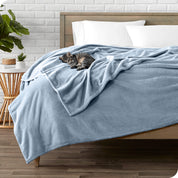 Microplush blanket laid out over a bed and folded back over itself