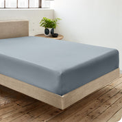 A single organic cotton fitted sheet on a bed