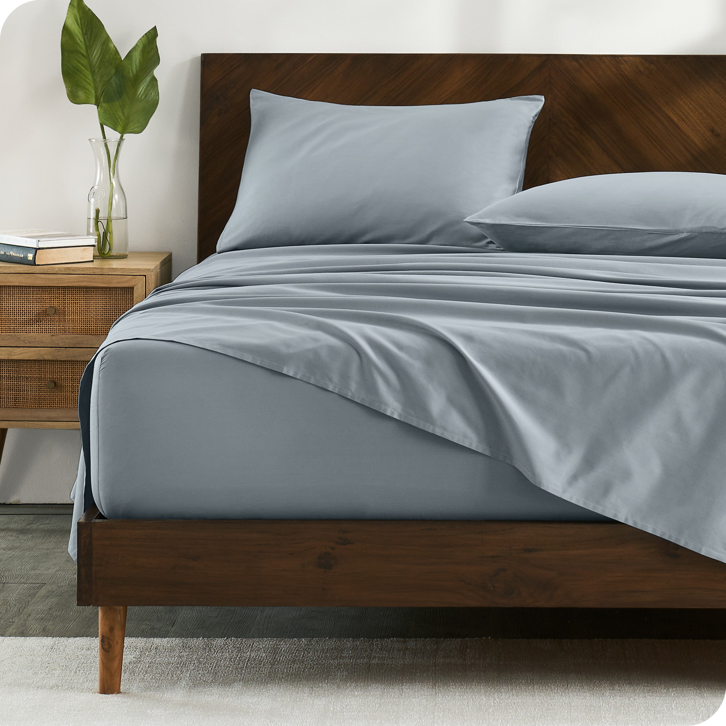 Percale sheets on bed in a modern bedroom