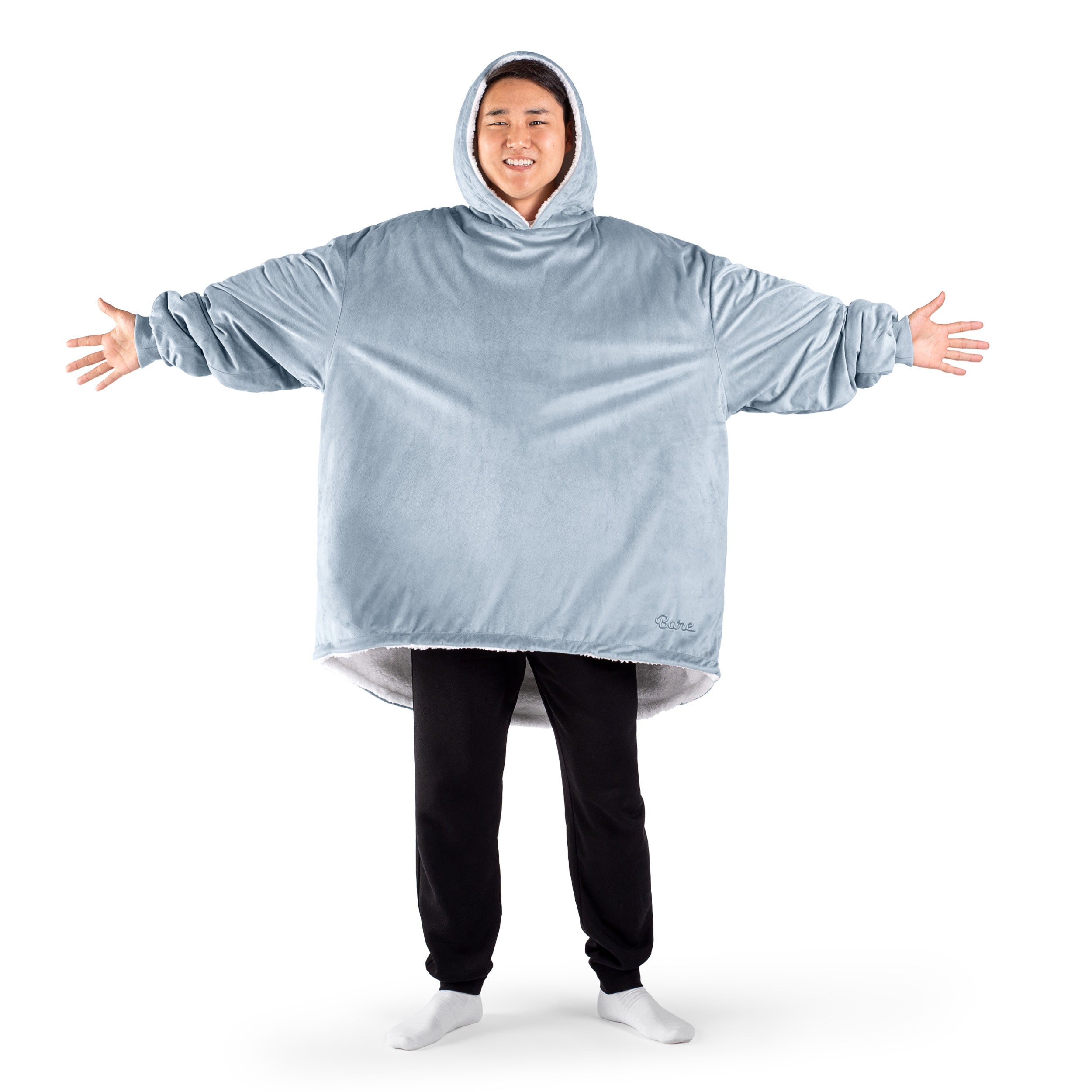 An adult with a sherpa wearable blanket on