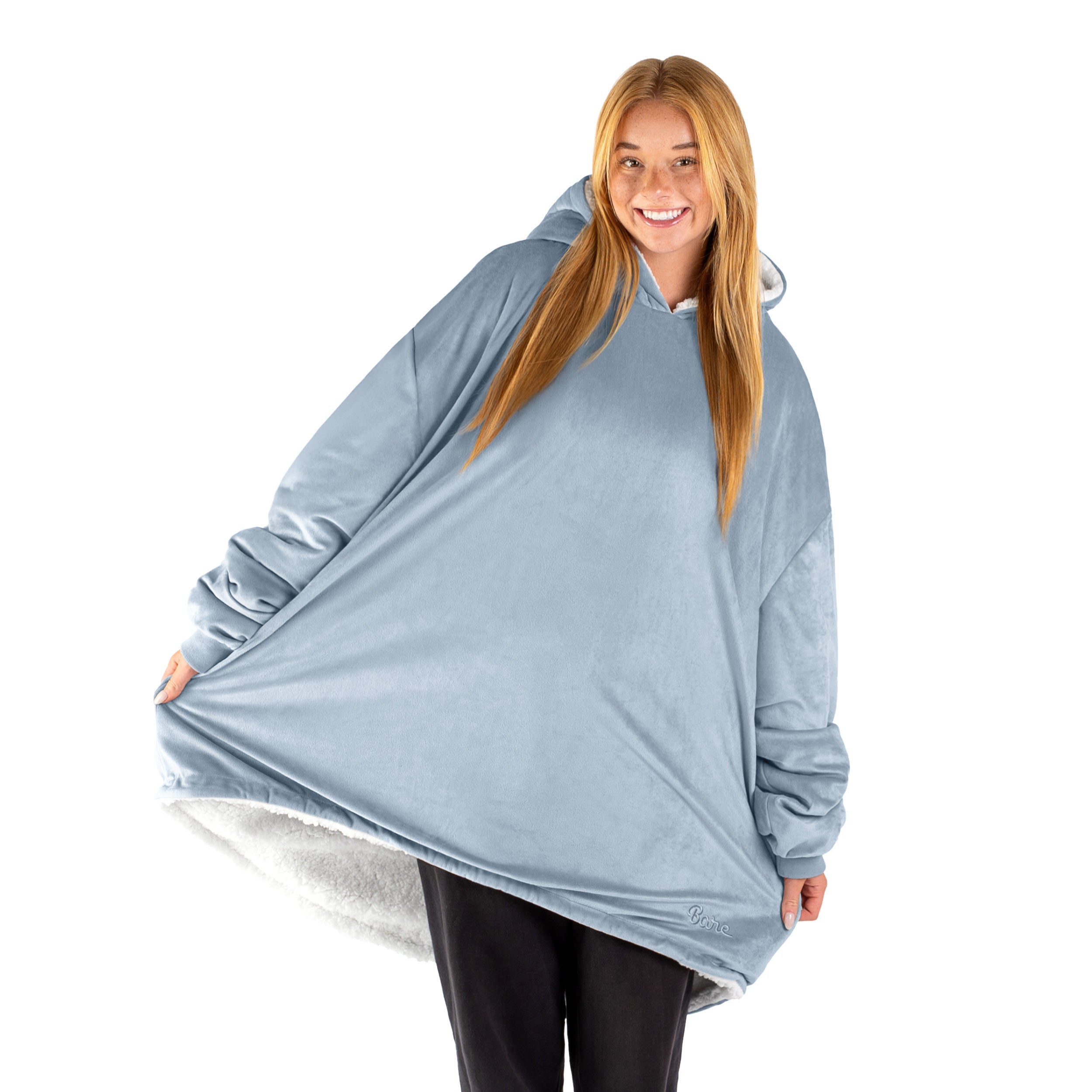An adult with a sherpa wearable blanket on