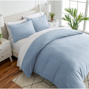 Angled view of bed with a duvet cover folded over on itself