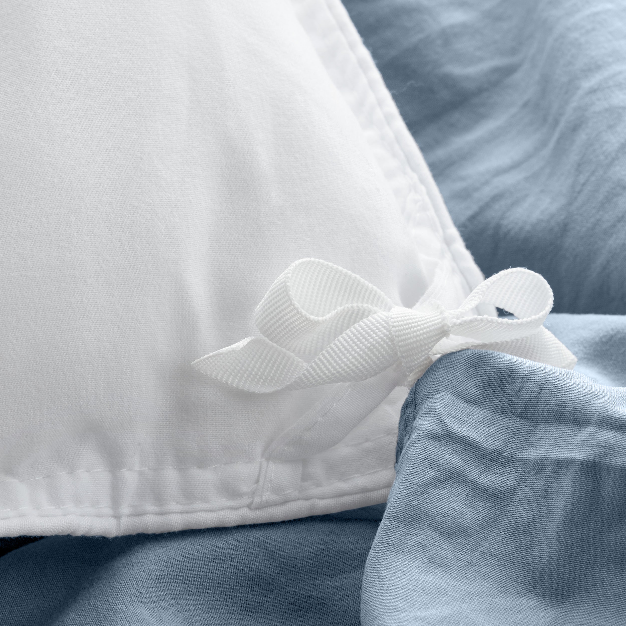Close up of cloth ties for attaching duvet insert to inside of duvet cover