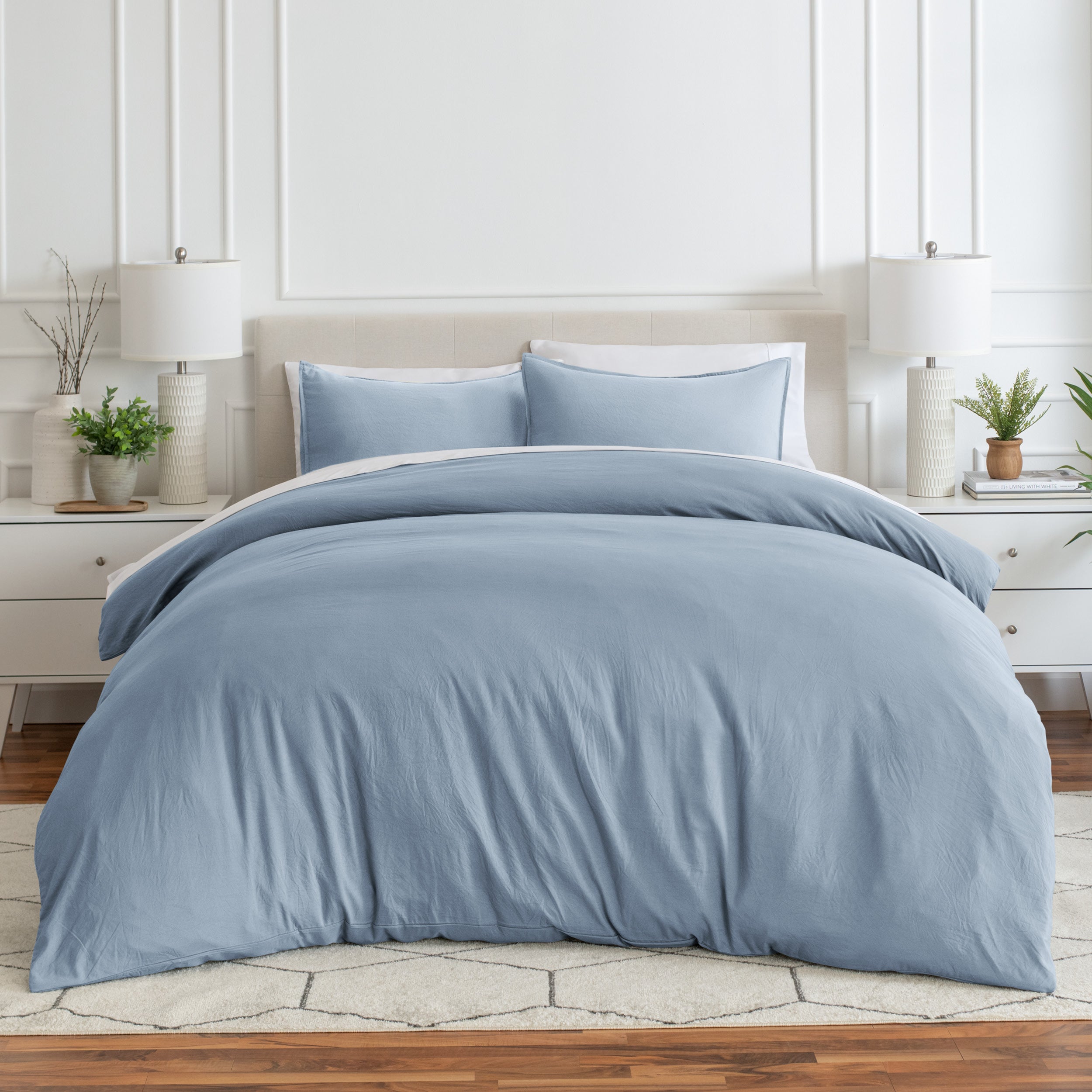 Relaxing room scene with a duvet cover laid out over the bed