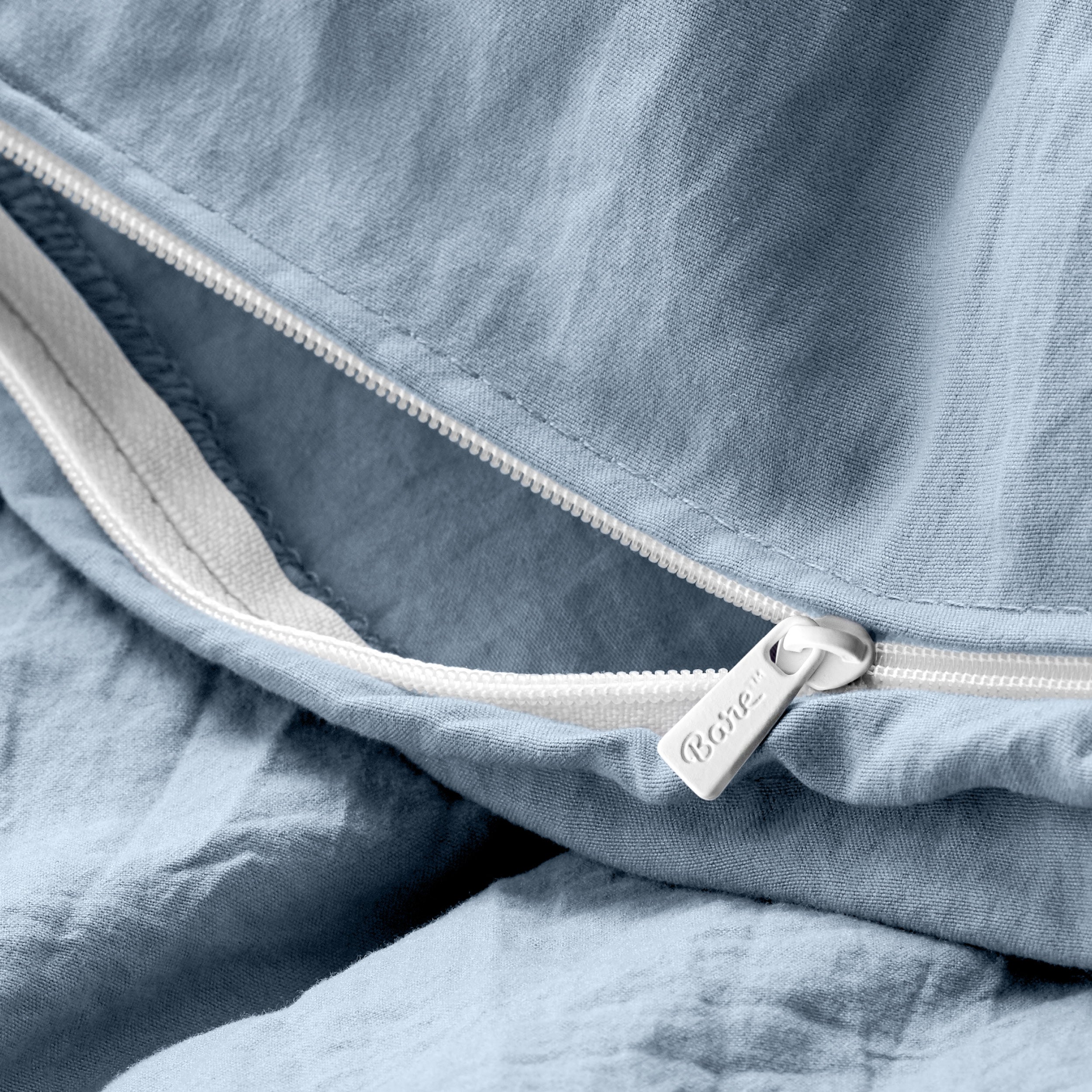 Close up of the zipper on the duvet cover partially opened