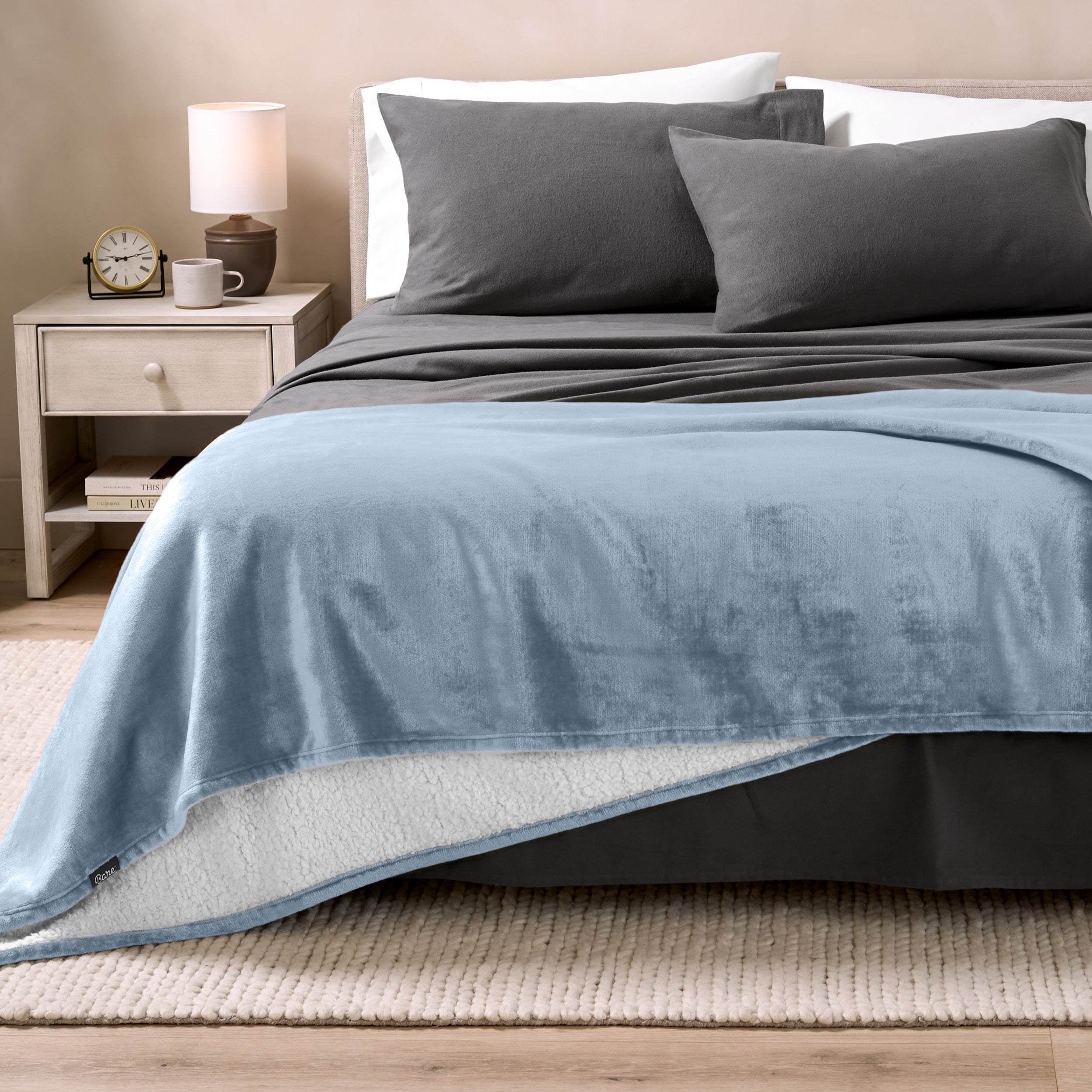 Sherpa Blanket laying on a bed folded over itself part way