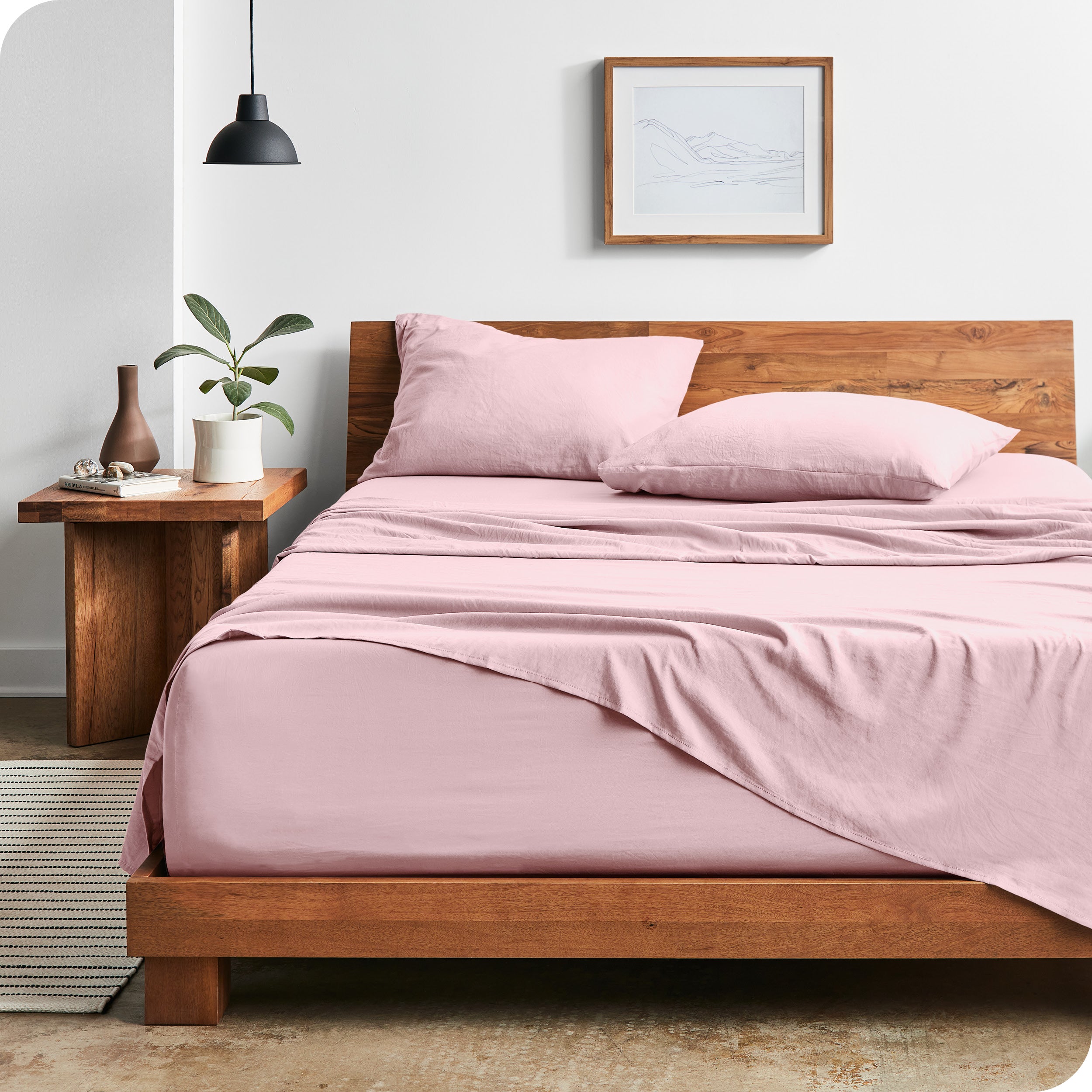 Modern bedroom with Sandwashed sheets draped over the end and side of mattress
