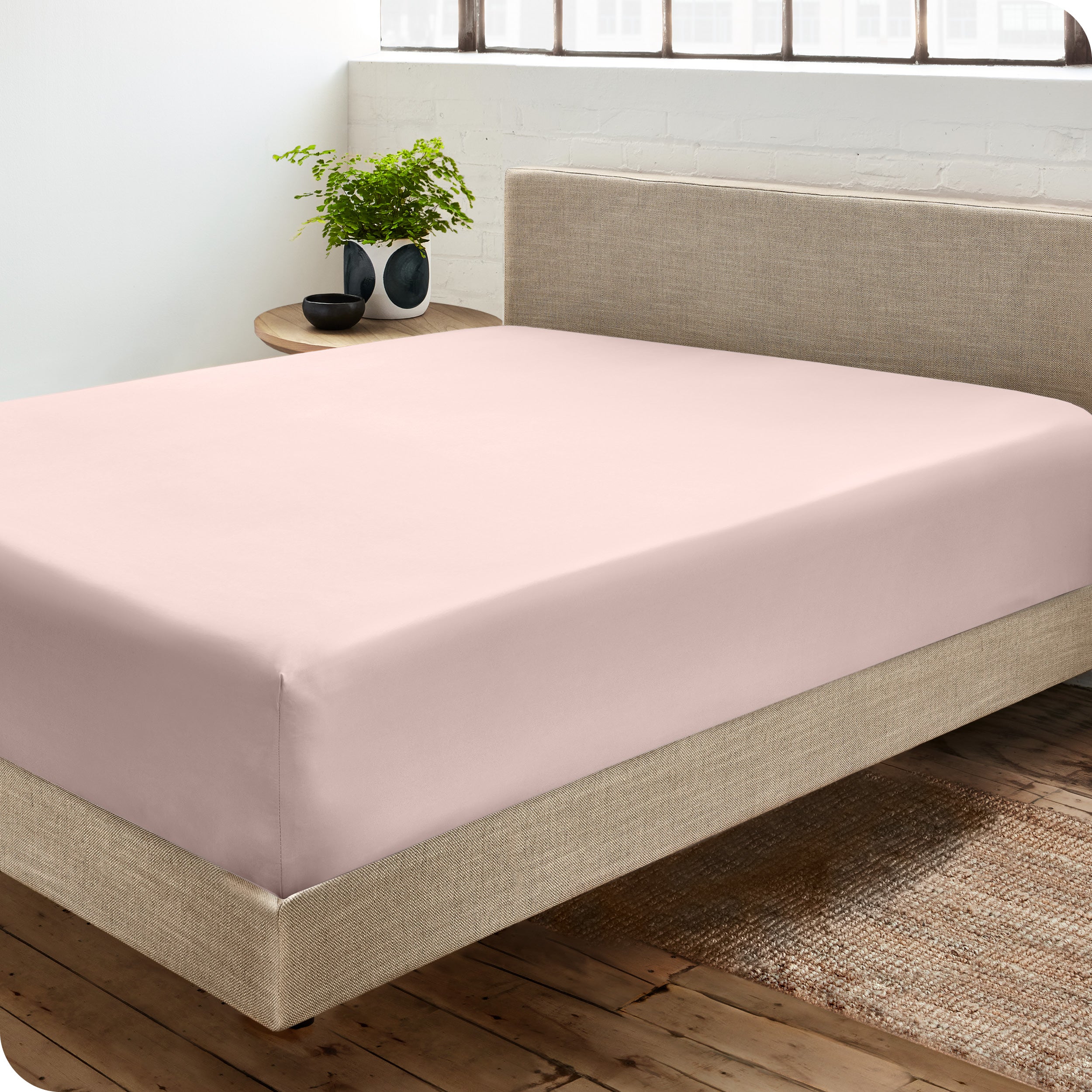 A sateen fitted sheet on a bed