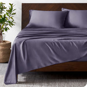 Wooden bed frame with bamboo sheets on the bed