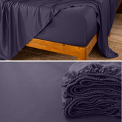 Bamboo fitted sheet on a wooden bed with a close-up of the folded sheet below.