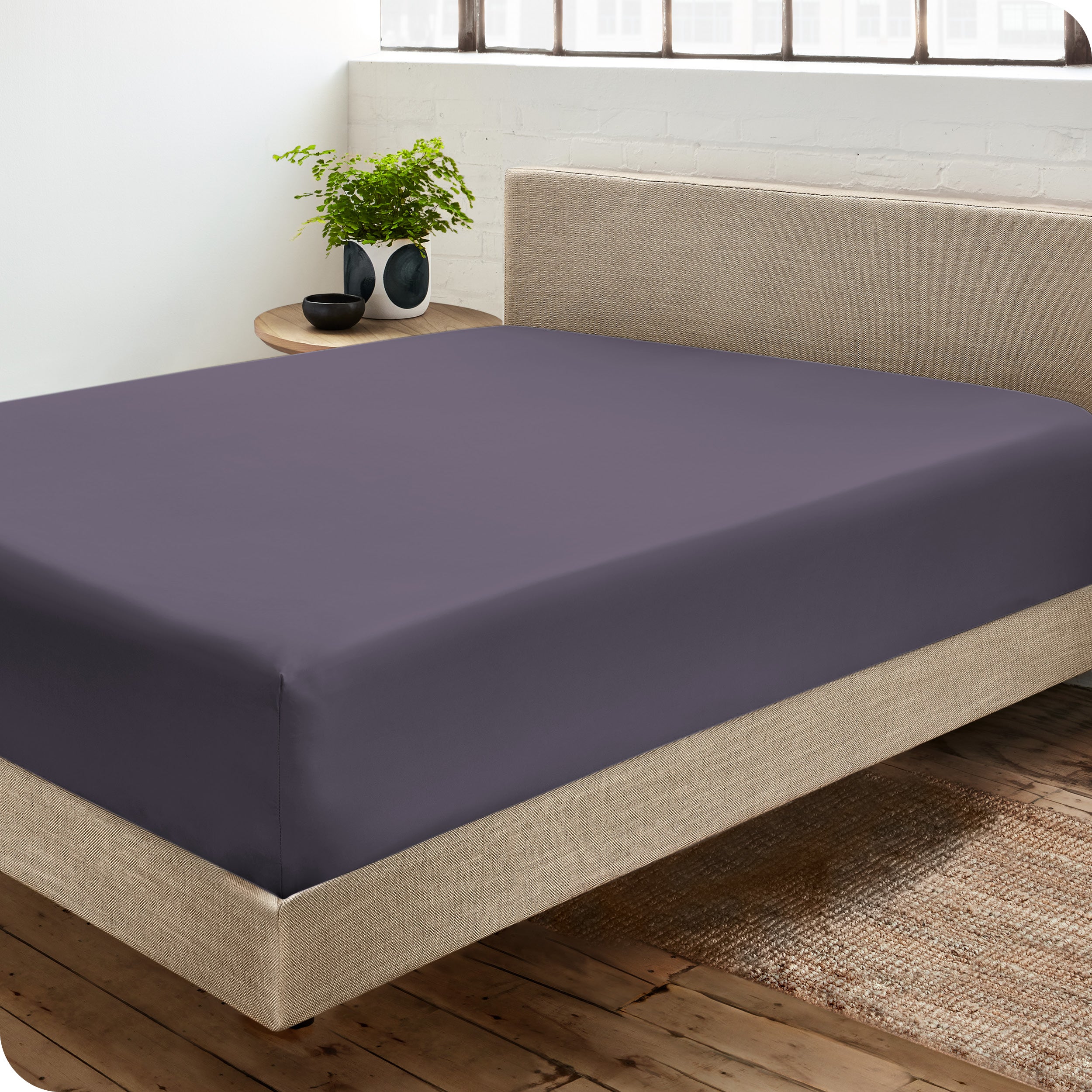 A sateen fitted sheet on a bed