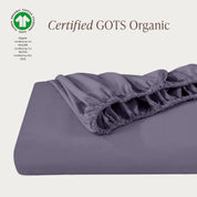 A single fitted sheet folded neatly showing part of the elastic. The fitted sheet is Certified GOTS Organic.