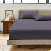 Percale fitted sheet on a mattress with matching pillowcases on pillows