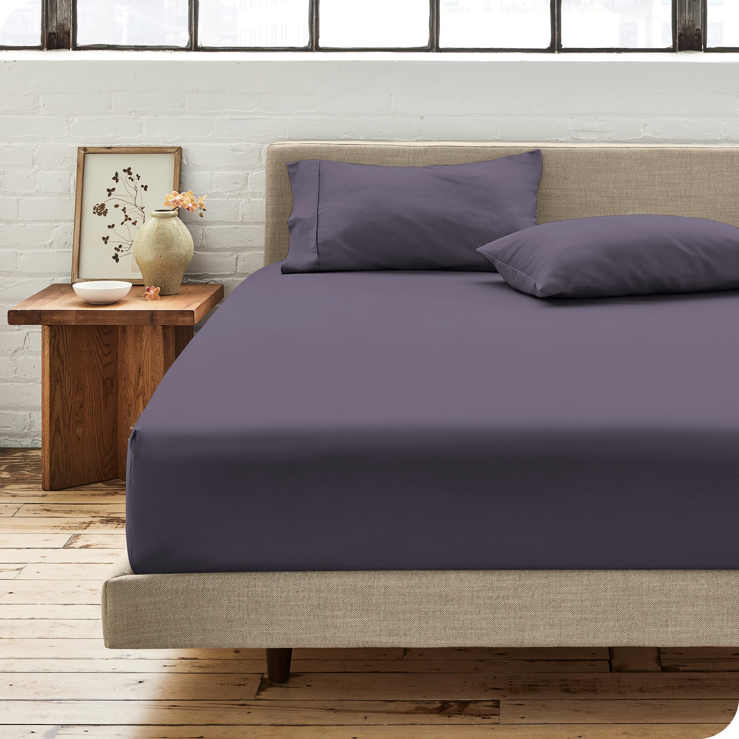 Percale fitted sheet on a mattress with matching pillowcases on pillows