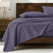 Percale sheet set on a bed with a wooden headboard