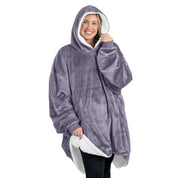 An adult with a sherpa wearable blanket on