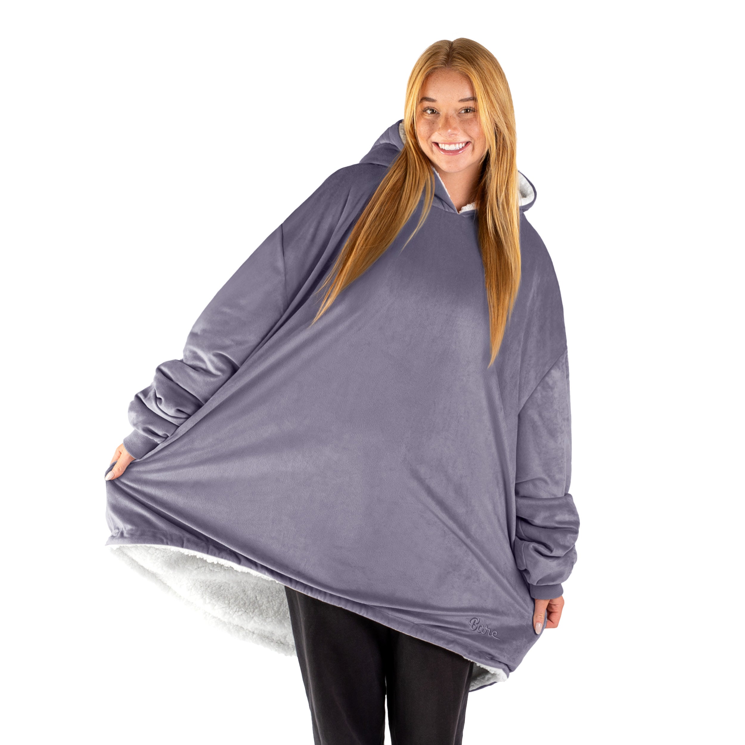 An adult with a sherpa wearable blanket on