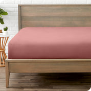 End of bed view with fitted sheet made on the mattress of a modern bed. 