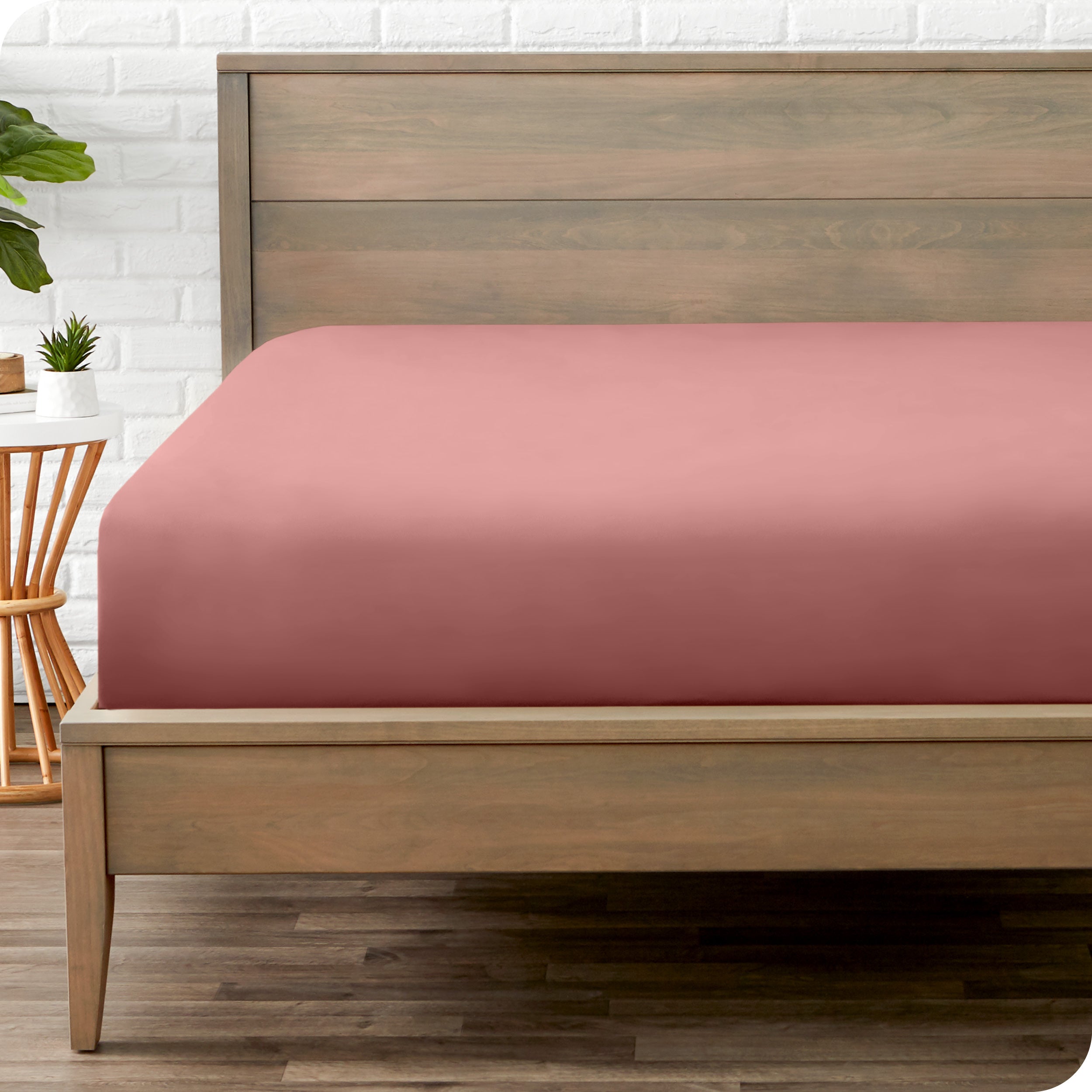 End of bed view with fitted sheet made on the mattress of a modern bed. 