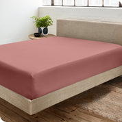 A sateen fitted sheet on a bed