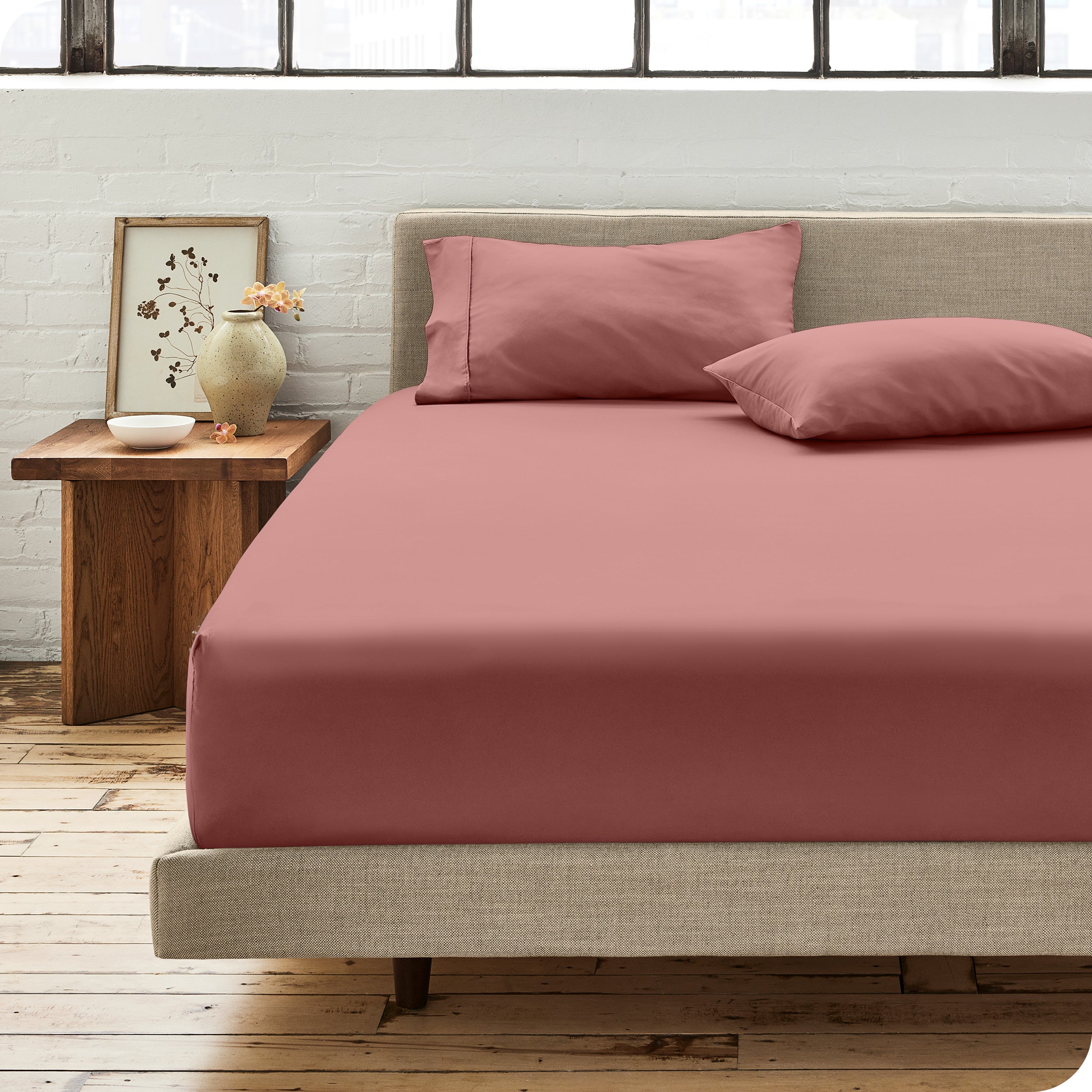 A single organic cotton fitted sheet on a bed
