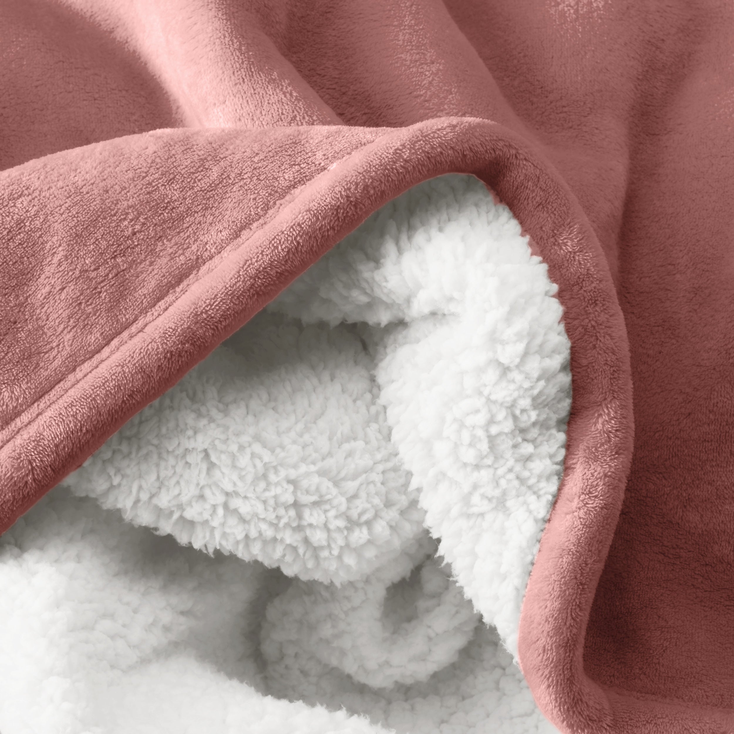 Close up of sherpa blanket showing texture of velvety soft side and sherpa backing