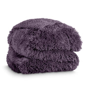A shaggy faux fur blanket folded