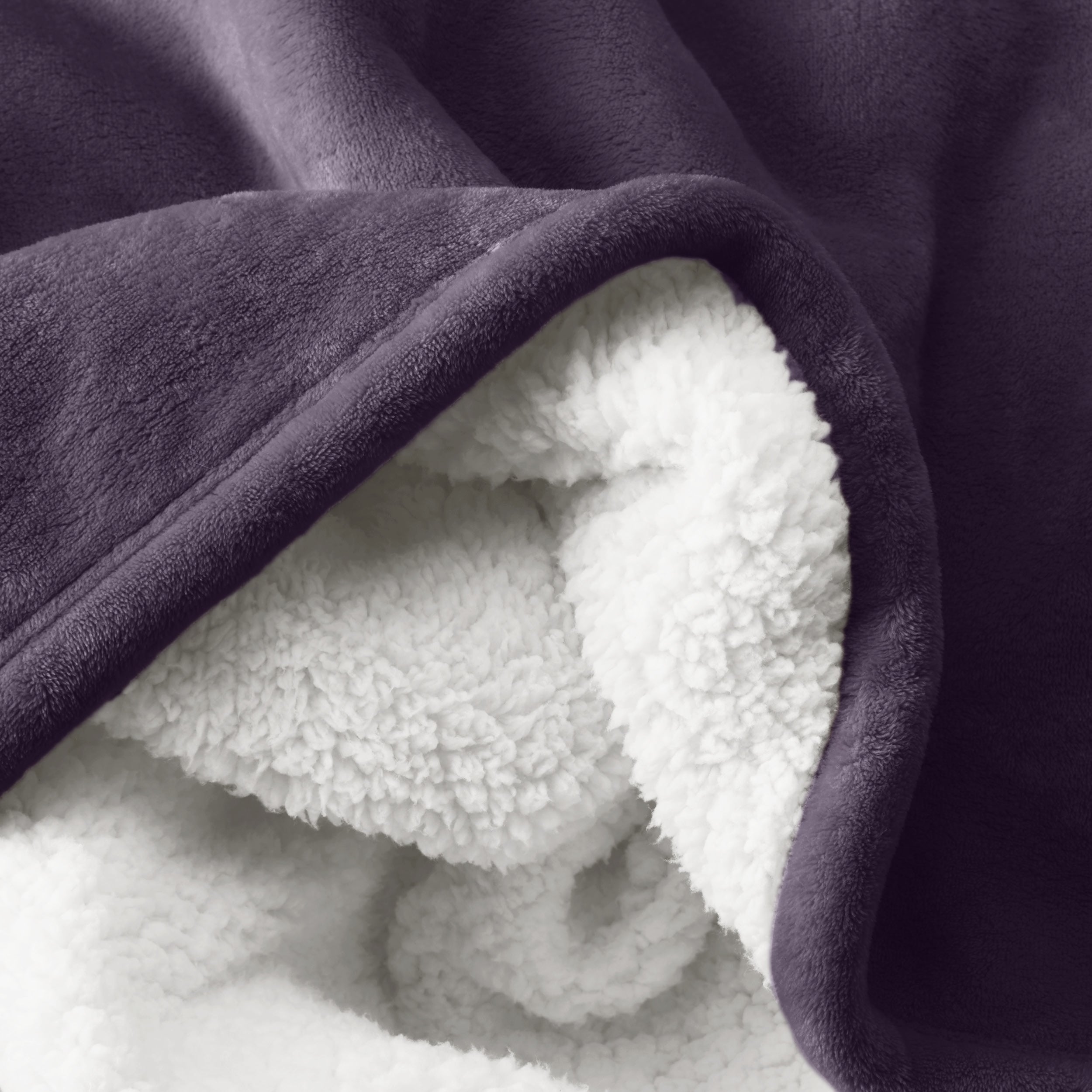 Close up of sherpa blanket showing texture of velvety soft side and sherpa backing