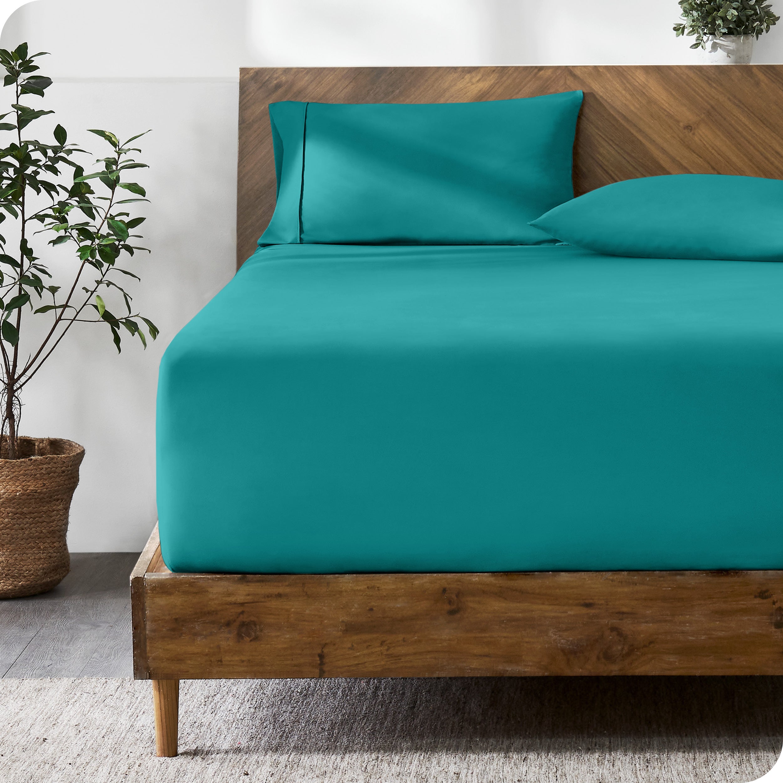 A modern bed with a fitted microfiber sheet made on the mattress. 