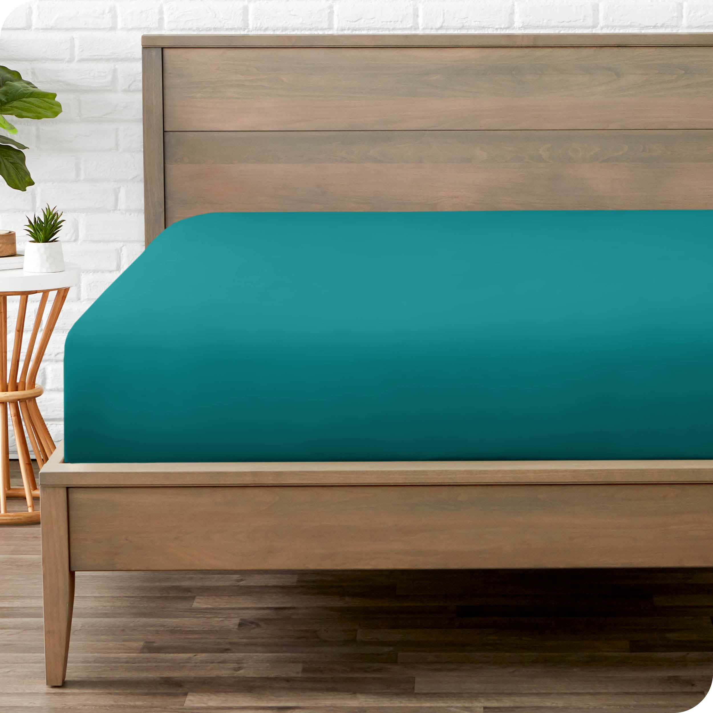 End of bed view with fitted sheet made on the mattress of a modern bed. 