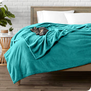 Microplush blanket laid out over a bed and folded back over itself