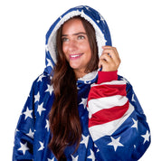 An adult with a sherpa wearable blanket on