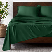 Wooden bed frame with bamboo sheets on the bed
