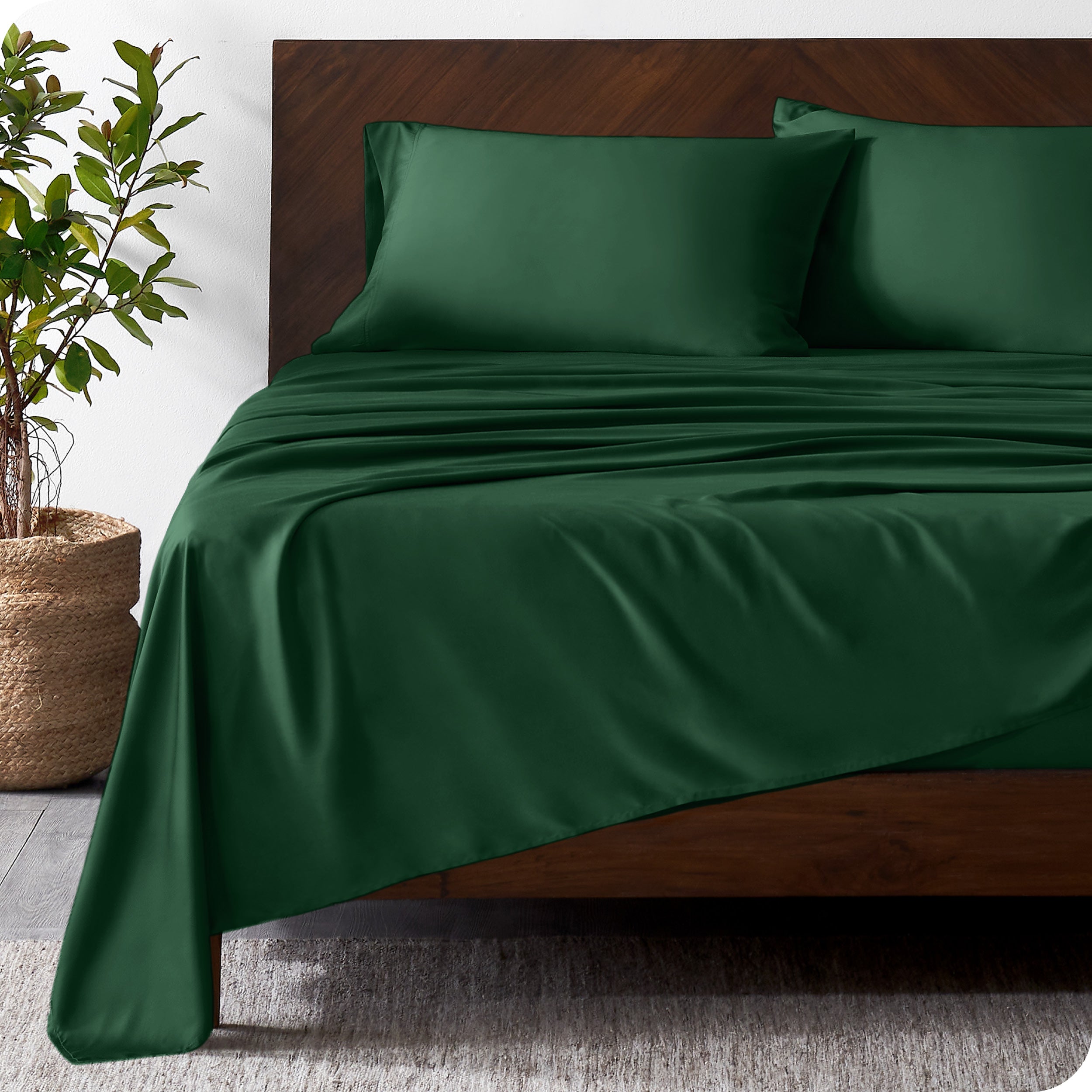 Wooden bed frame with bamboo sheets on the bed